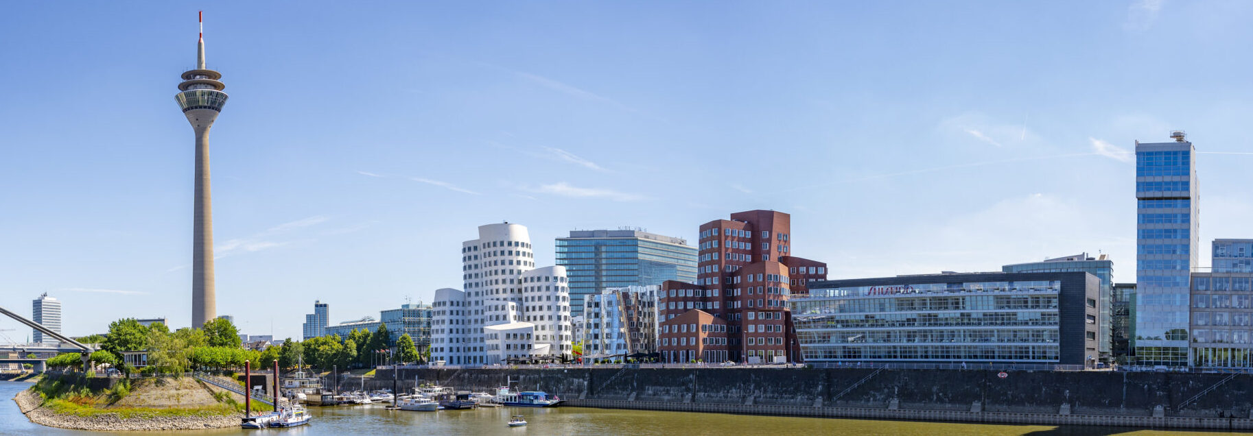 Düsseldorf Medienhafen (Media Harbour) modern architecture on the banks of the river Rhine during a beautiful summer day in North Rhine-Westphalia, Germany.